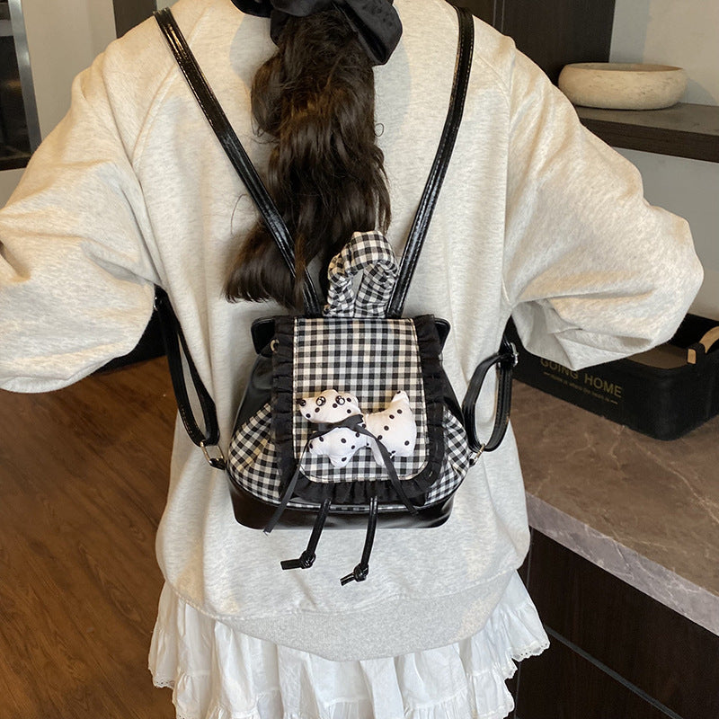 Playful backpack with checkered pattern and animal appliqué Kalsten