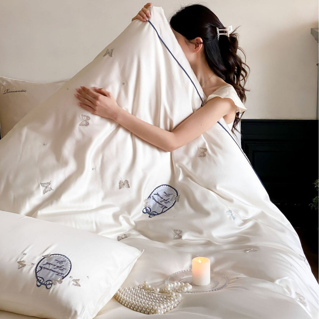 Luxurious cotton satin bedding set with embroidered butterfly appliqués and fine piping
