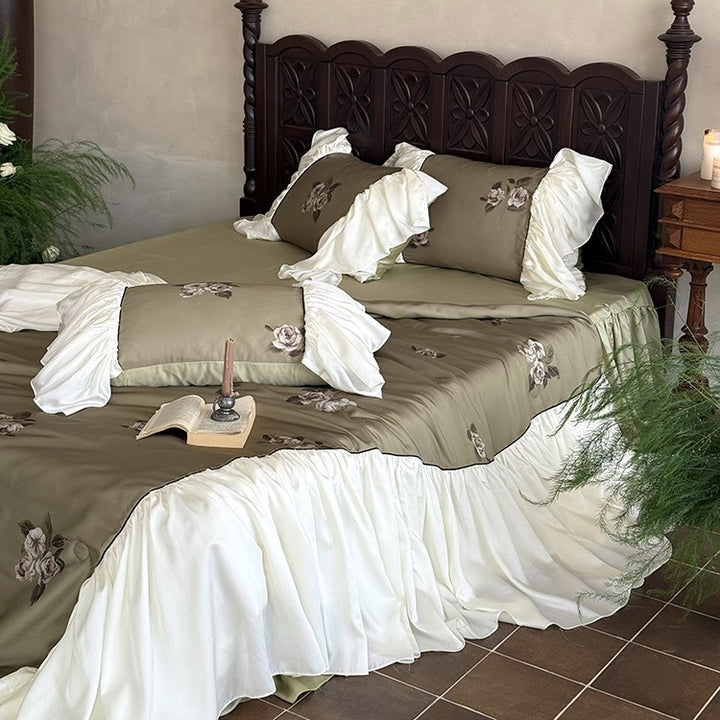 Romantic cotton satin bedding set with ruffled bed skirt and embroidered rose appliqués