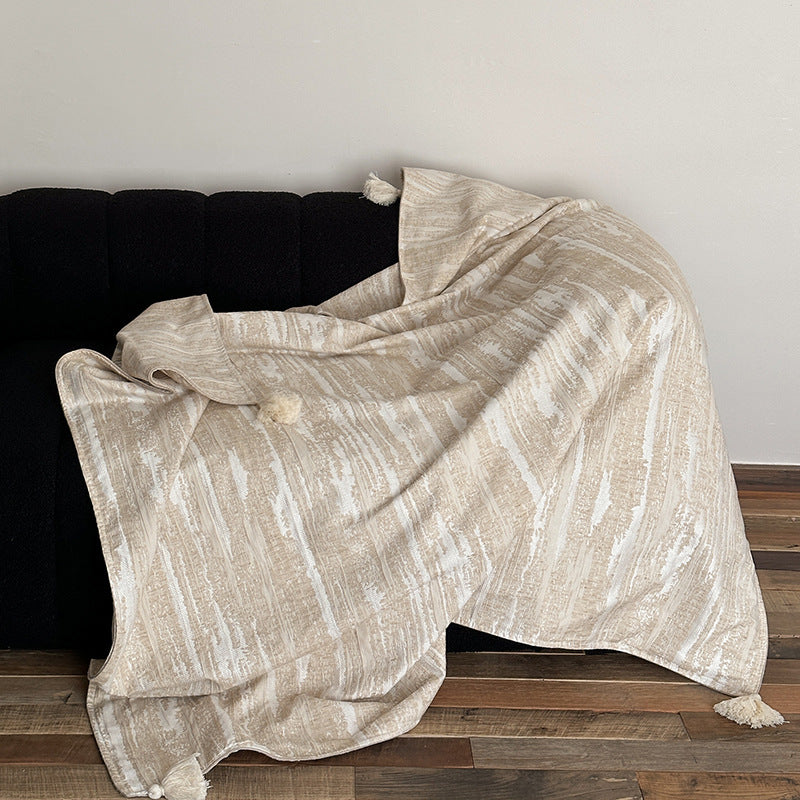 Woven blanket made of cotton blend with decorative tassels