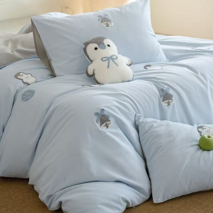 Children's bedding set with embroidered penguin appliqués and plush cuddle details