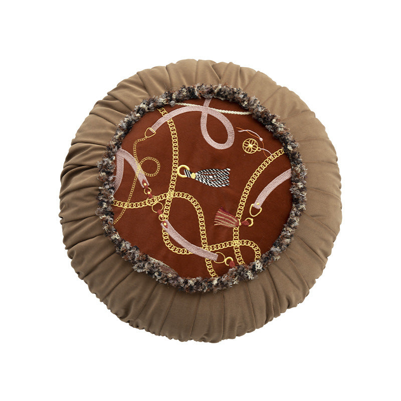 Round decorative cushion with pleated hem and embroidered central panel