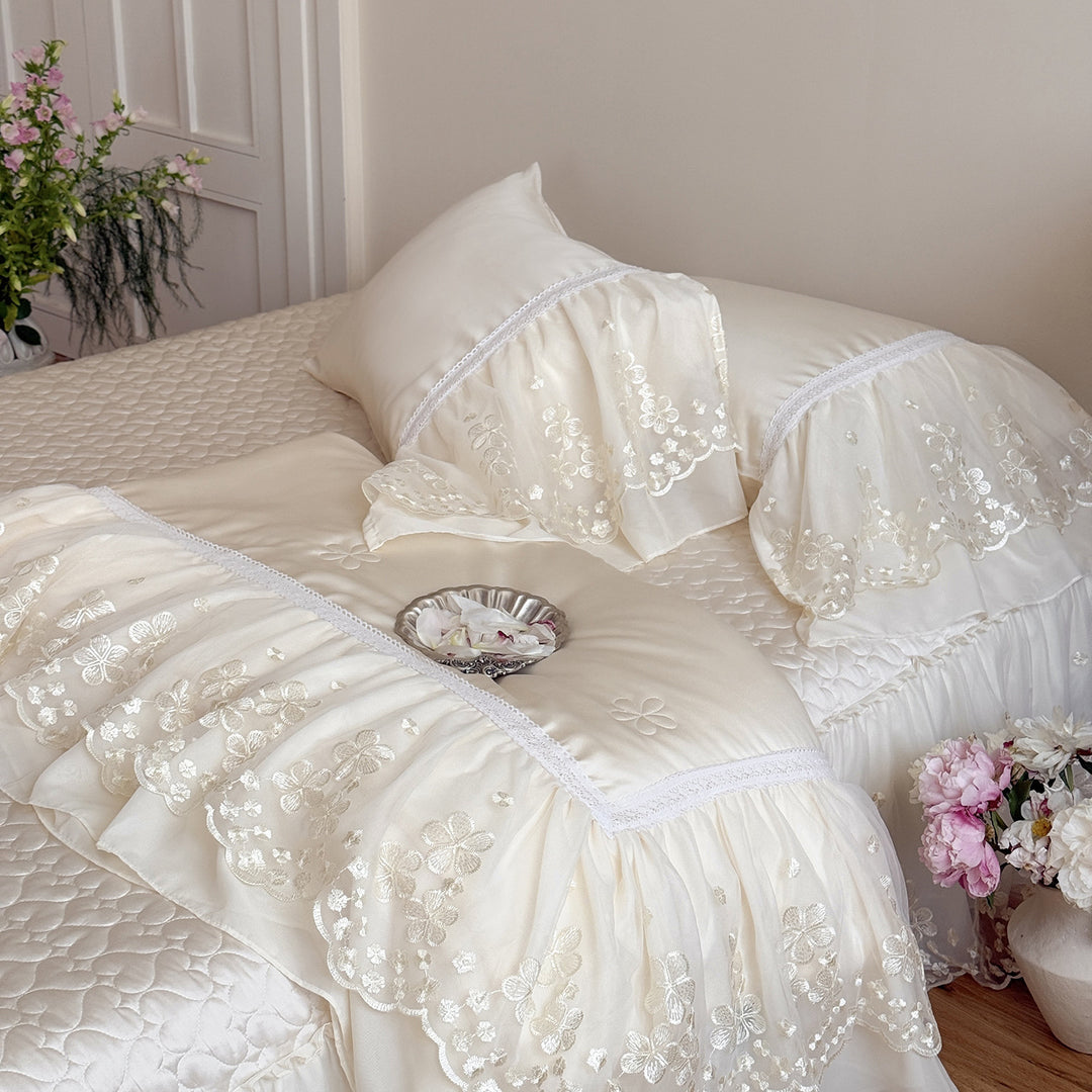 Satin bed linen set with embroidered chiffon ruffle and quilted bedspread