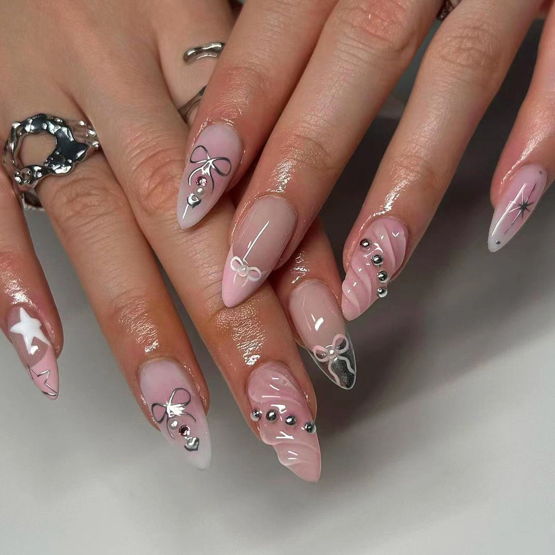 Artistic Nail Art with decorative bows and glitter accents Kalsten