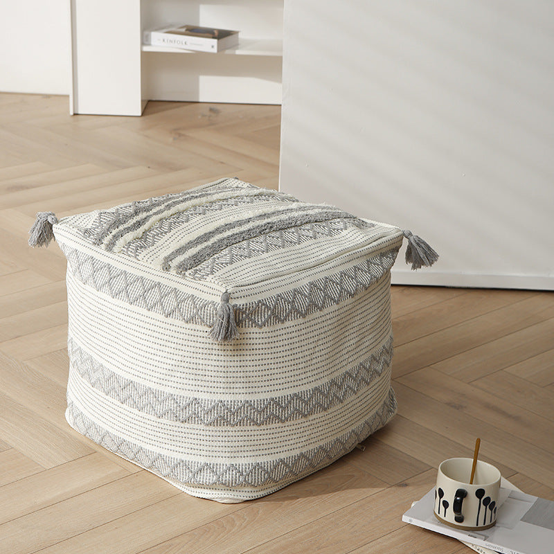 Braided square floor seat pouf with tassels and woven ethnic pattern