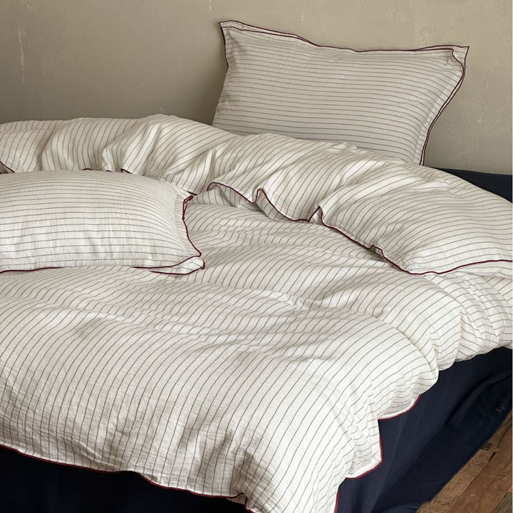 Cotton duvet cover set with fine pinstripes and subtle embroidery applications