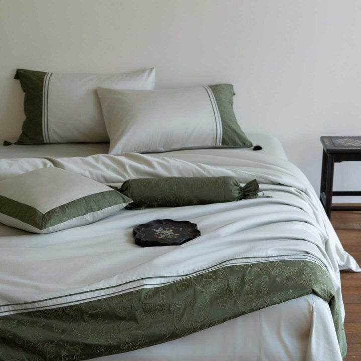 Luxurious cotton satin bedding set with decorative borders and decorative pillows