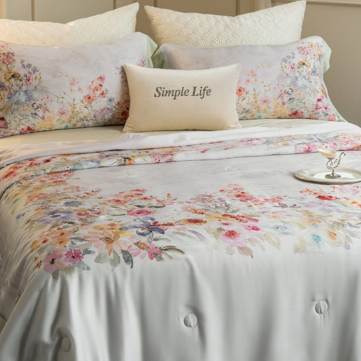 Luxurious cotton satin bed linen set with delicate floral print and quilted bedspread