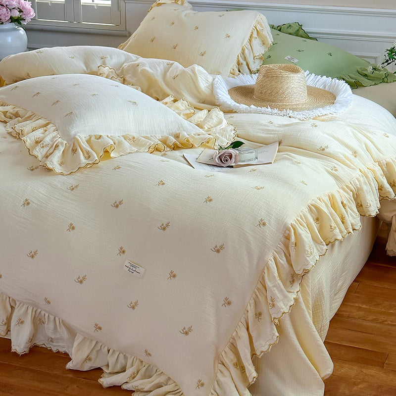 Vintage-inspired bedding set with ruffles and delicate floral embroidery