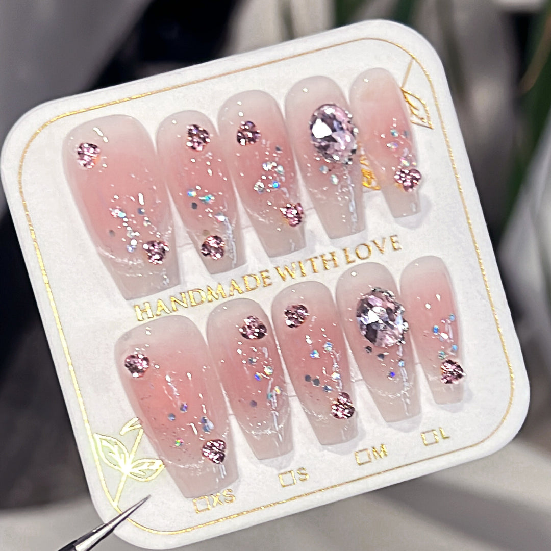 Artificial nail extensions with artistic glitter accents Kalsten