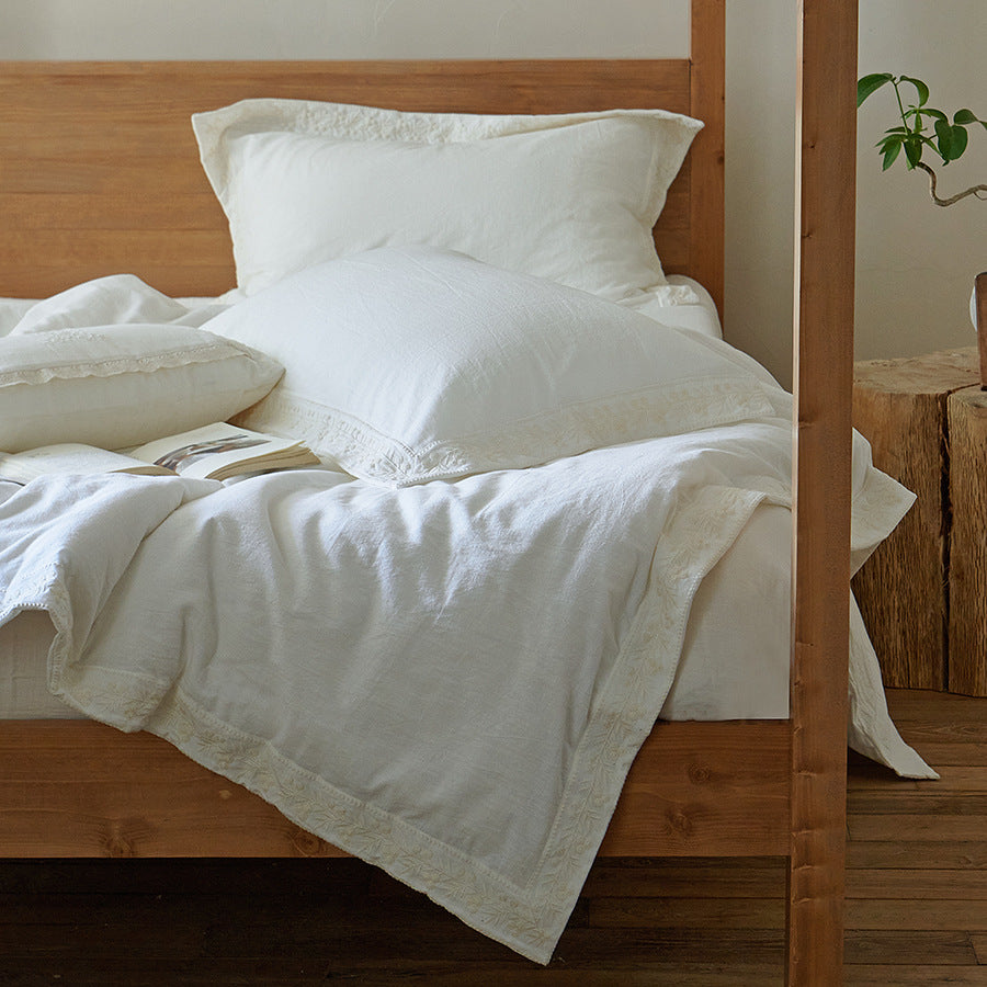 Cotton gauze bedding set with fine tone-on-tone floral embroidery and ruffle