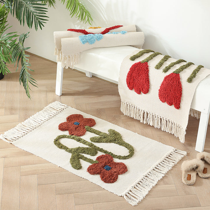 Handwoven cotton bath mat rug with tufted flower appliqué and tassels Kalsten