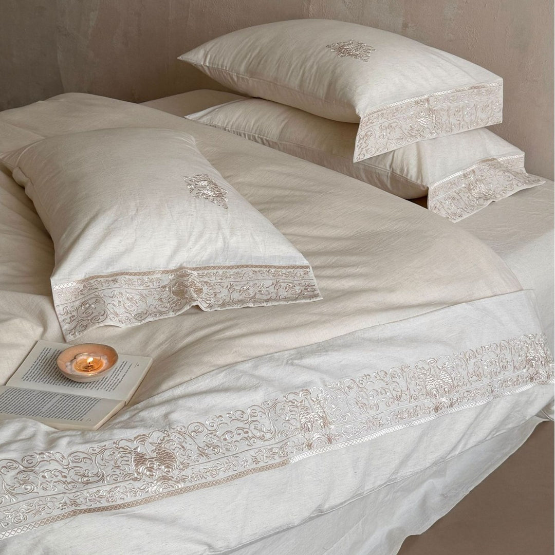 Fine linen bed linen set with floral tone-on-tone embroidery and hem detail