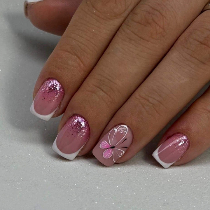 Artistic nail art with glitter and butterfly design Kalsten