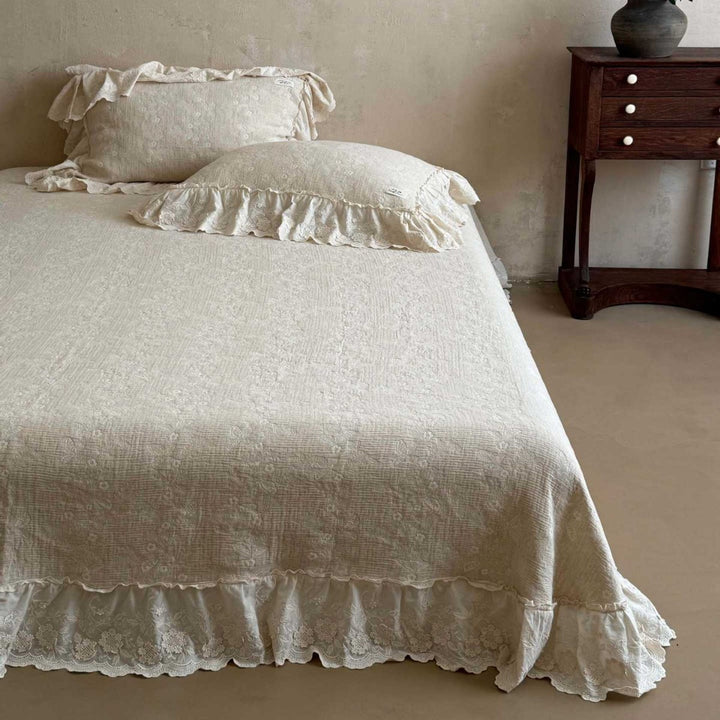 Vintage-inspired ruffled bedding set made of cotton muslin with fine floral embroidery