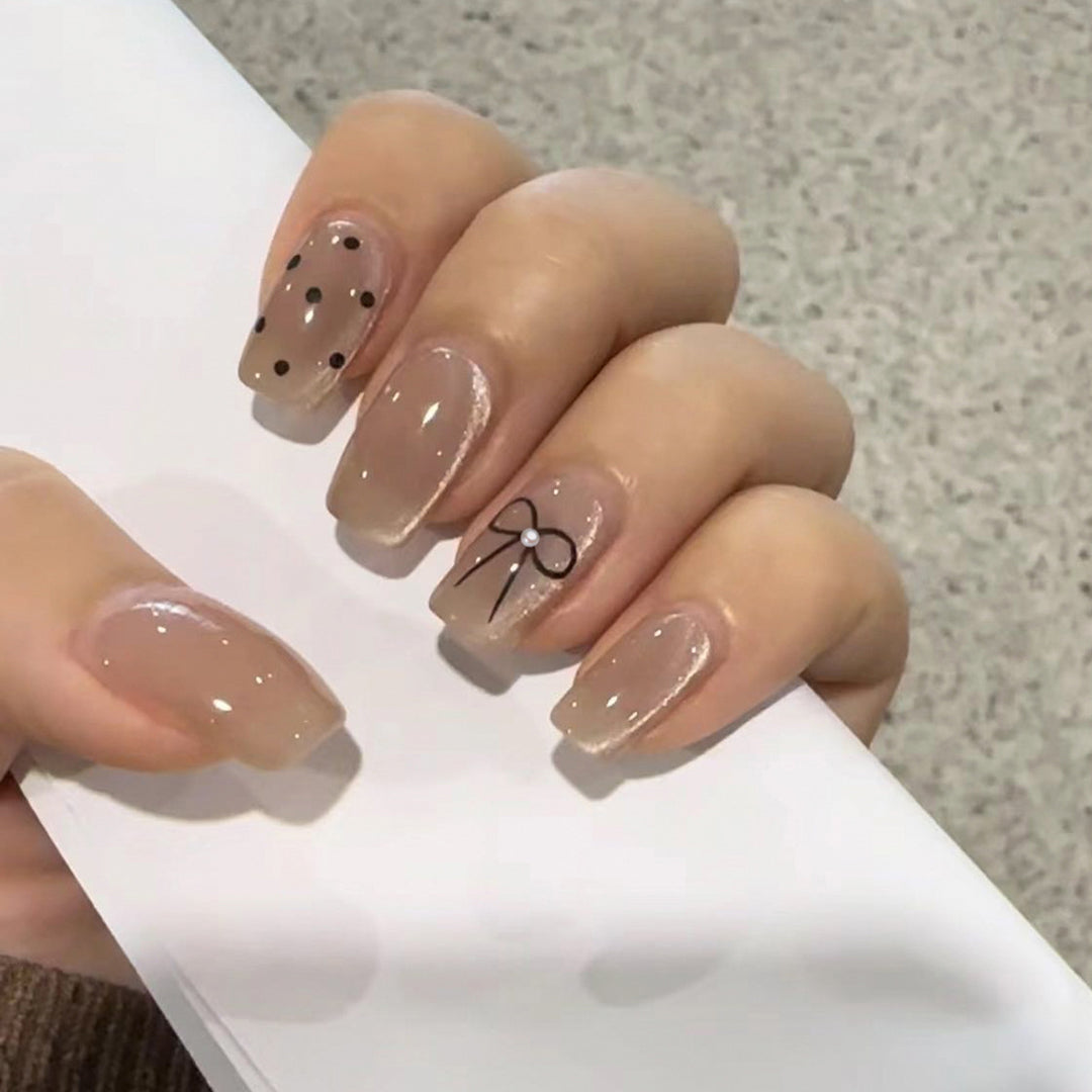 Artificial nail extensions with decorative bows and dots Kalsten