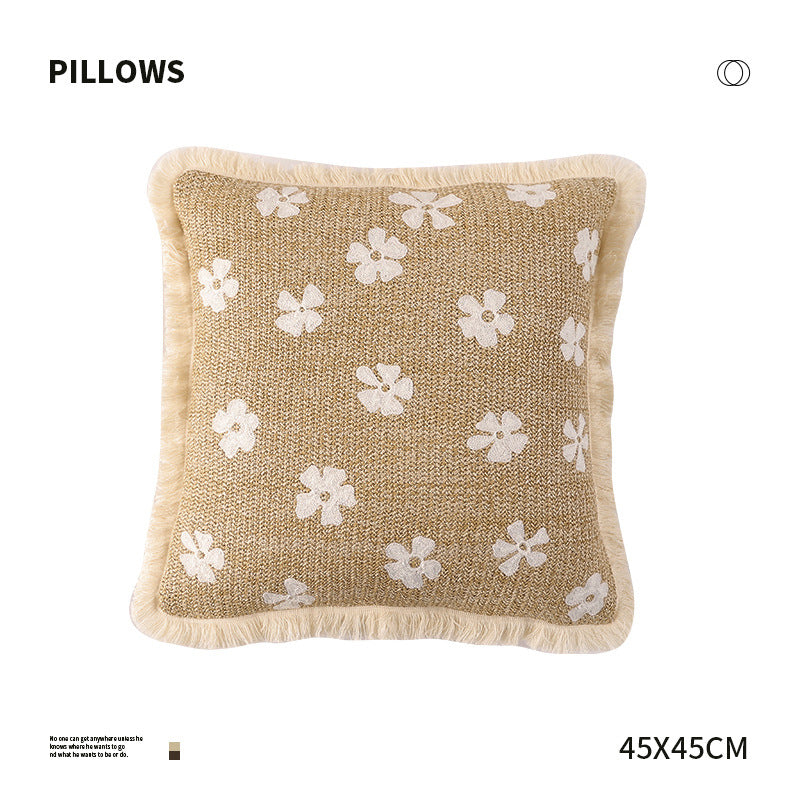 Rectangular woven decorative pillow with contrasting flower tufting and fringe trim