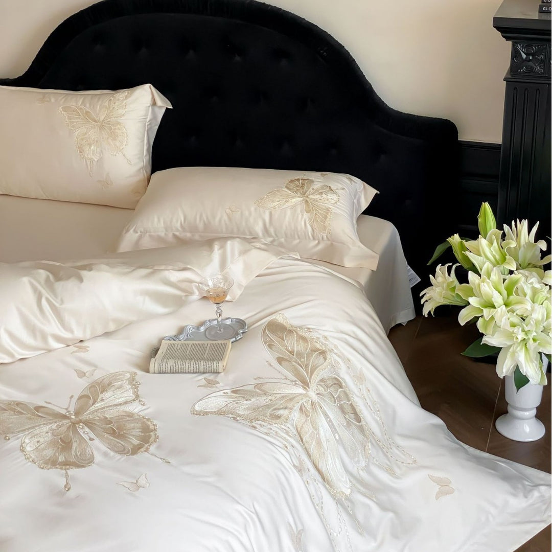 Luxurious satin bedding set with embroidered butterfly motifs and silky glossy finish