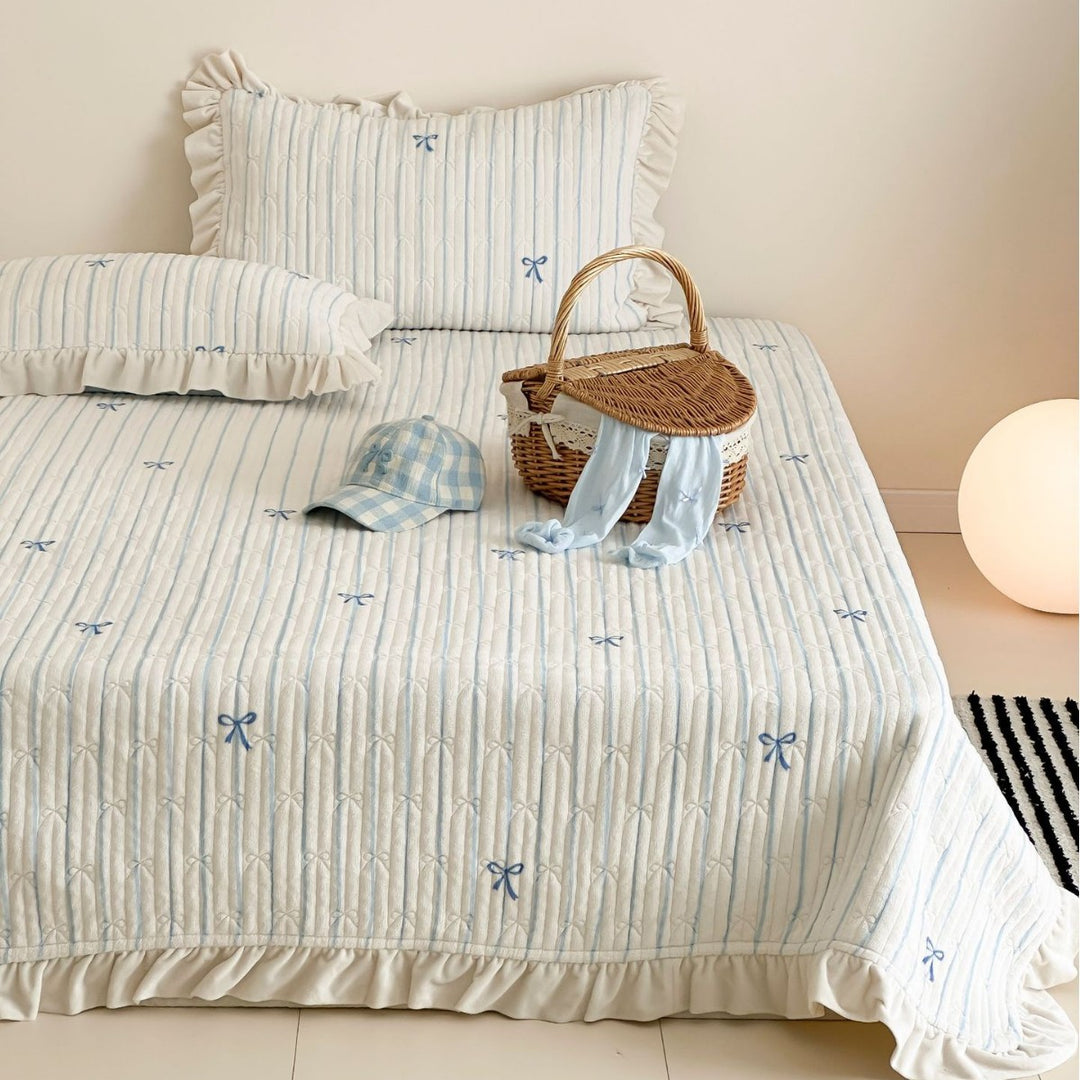 Padded bedding set with embroidered bows and frill