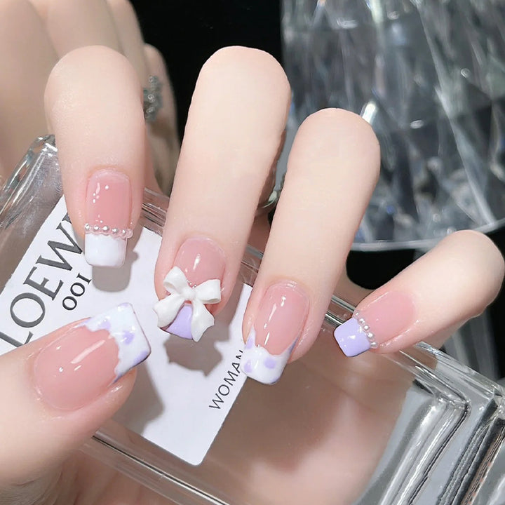 Nail art set with elegant wave patterns and delicate pearl accents Kalsten