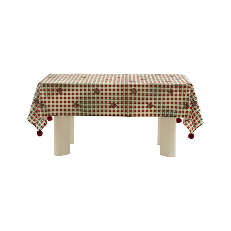 Checked flannel tablecloth with pom-pom tassels and traditional tartan pattern