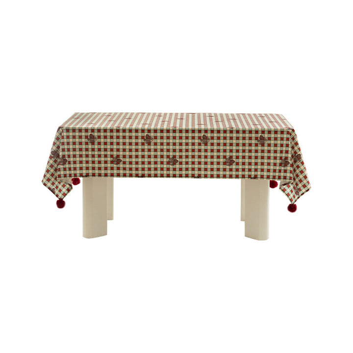 Checked flannel tablecloth with pom-pom tassels and traditional tartan pattern