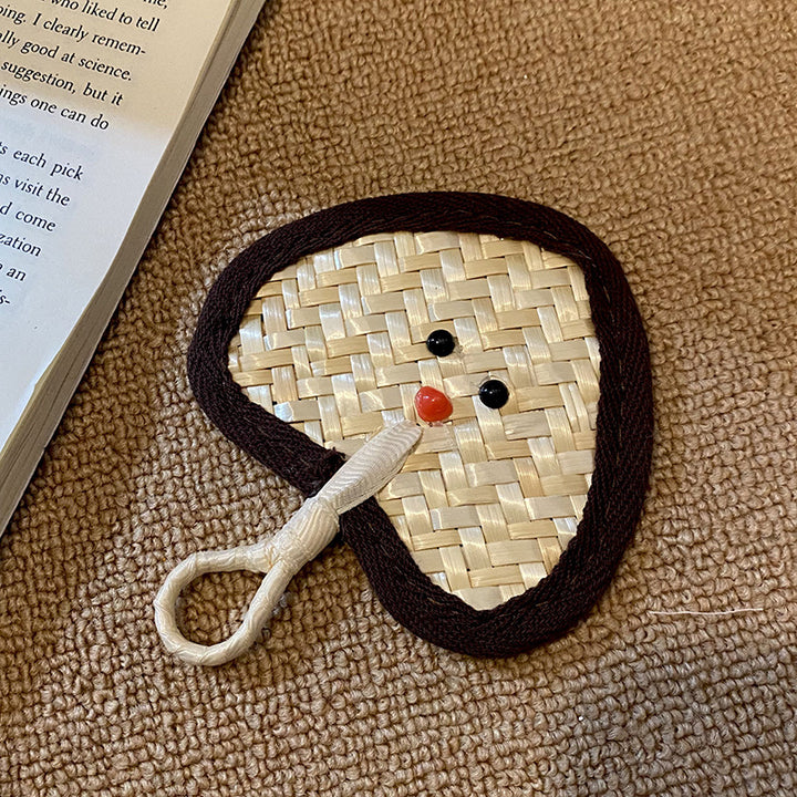 Handcrafted fan with playful face motif Kalsten
