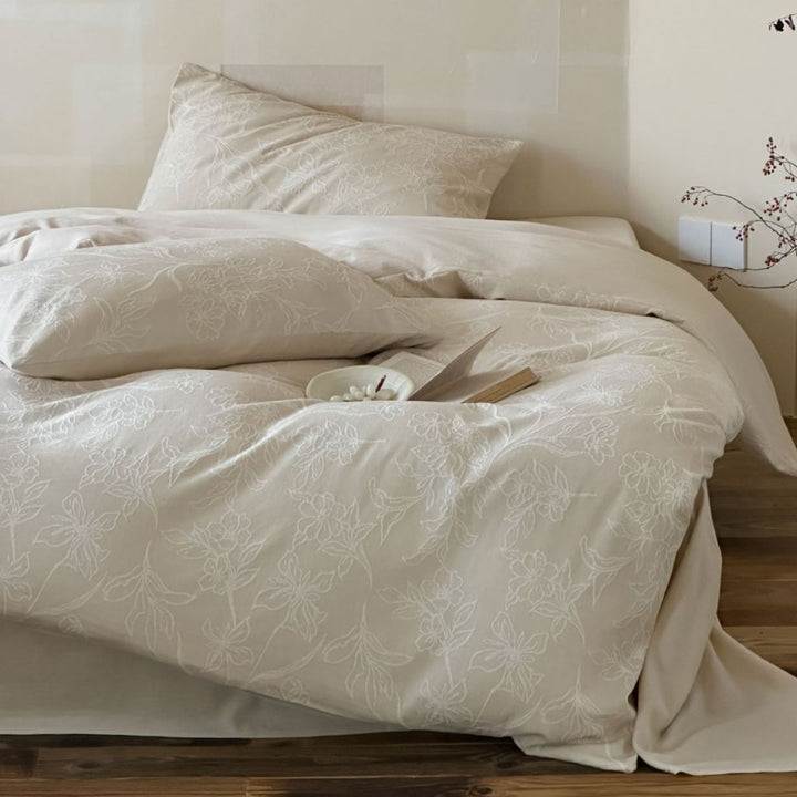 Finely woven cotton bedding set with embroidered floral relief and reversible cover