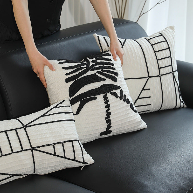 Decorative cushion cover with textured embroidery and geometric line motif