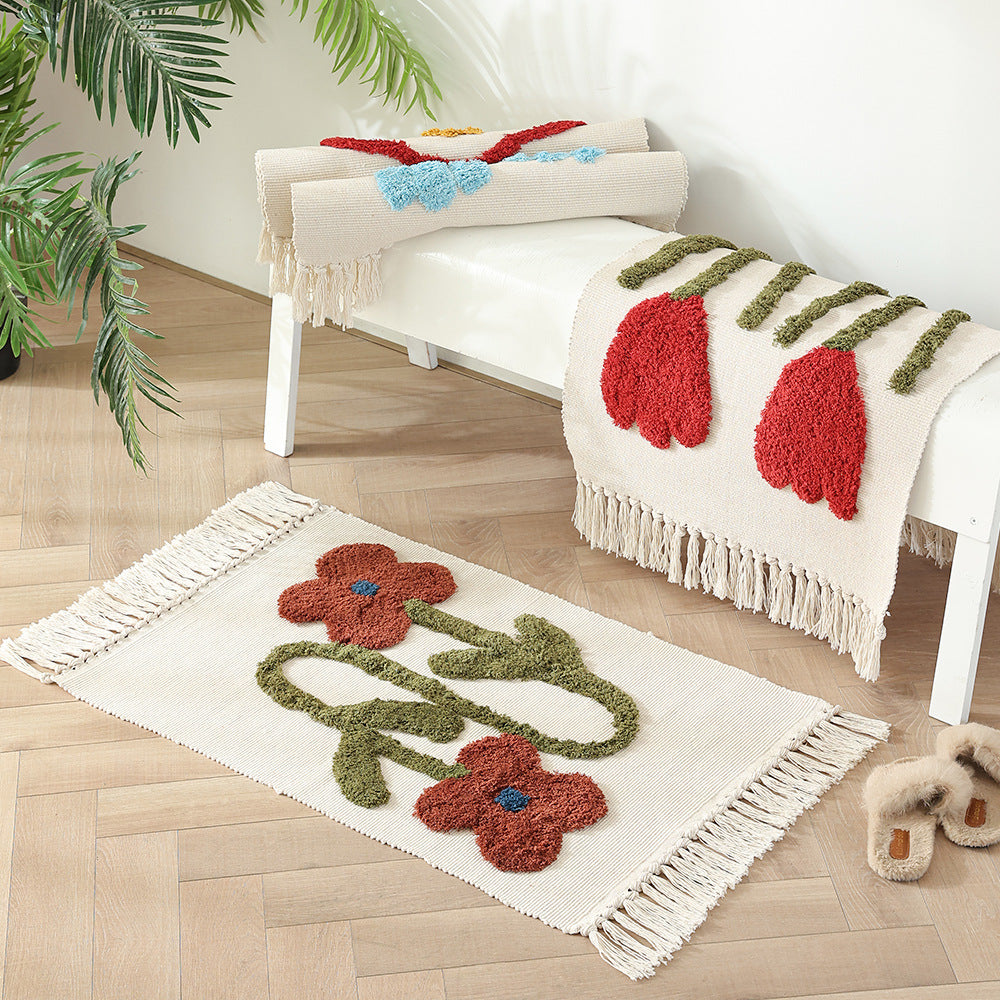 Decorative cotton bath mat with fringes and textured floral border
