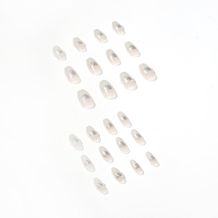 Artificial nail art with heart and rhinestone decorations Kalsten