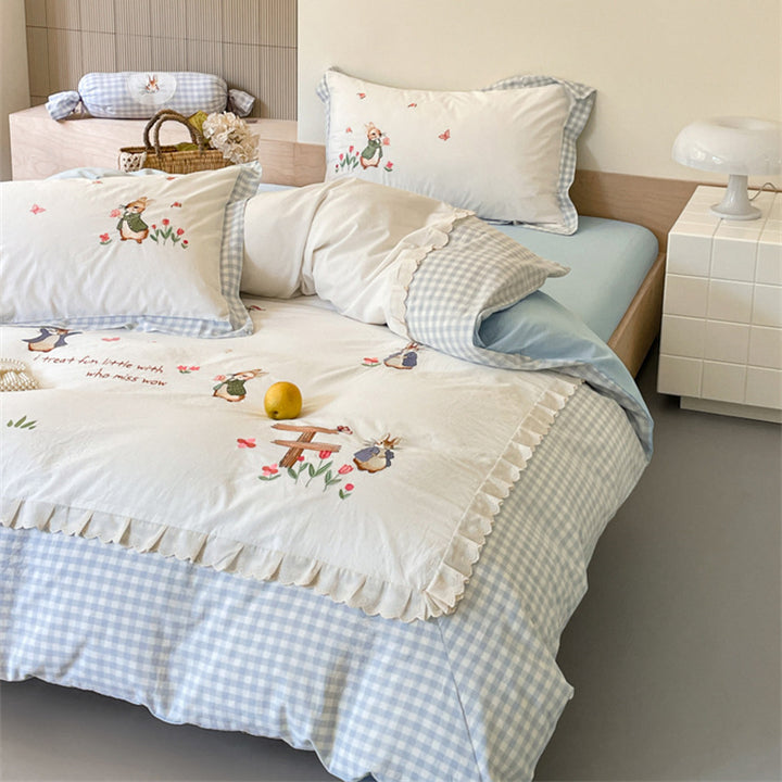 Romantic bedding set with embroidered rabbit motifs and delicate ruffles