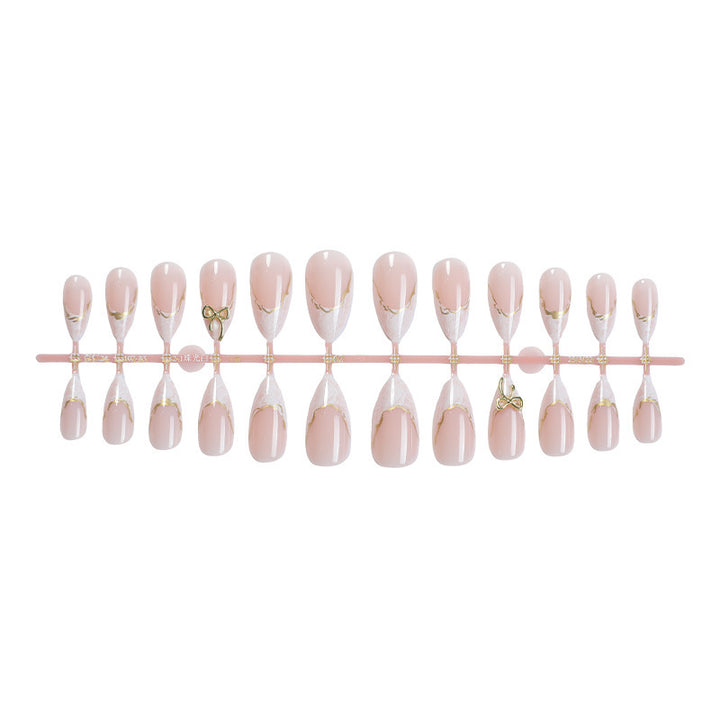 Acrylic nail set with elegant tips and gold embellishments Kalsten