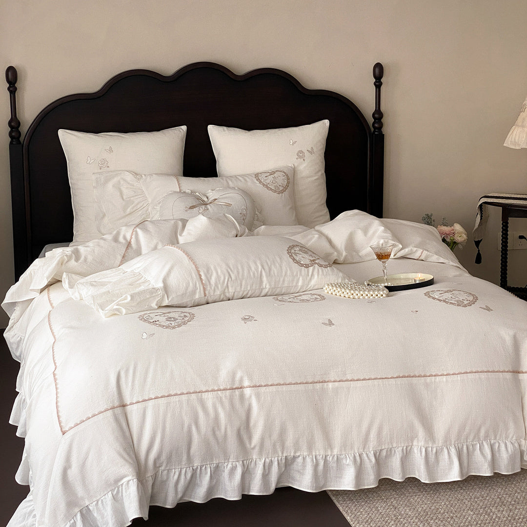 Romantic bedding set with ruffles, heart embroidery, and linen look