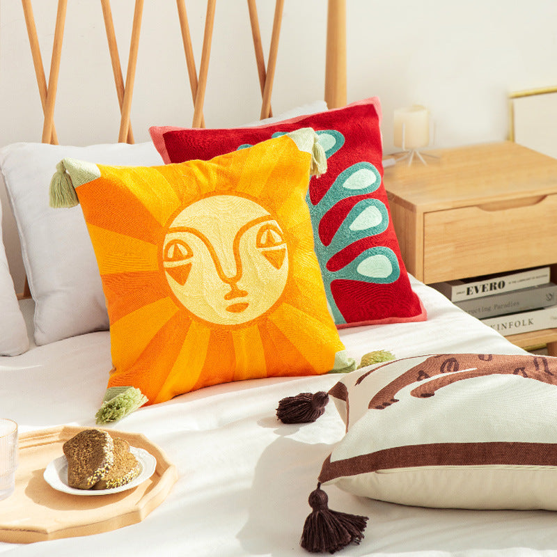 Square cushion cover in graphic geometric relief with decorative tassels