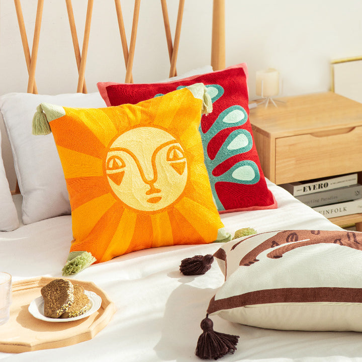 Square cushion cover in graphic geometric relief with decorative tassels