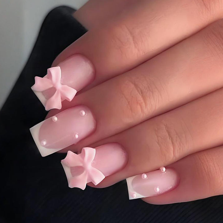 Glamorous artificial nail set with elegant bows and glitter accents Kalsten