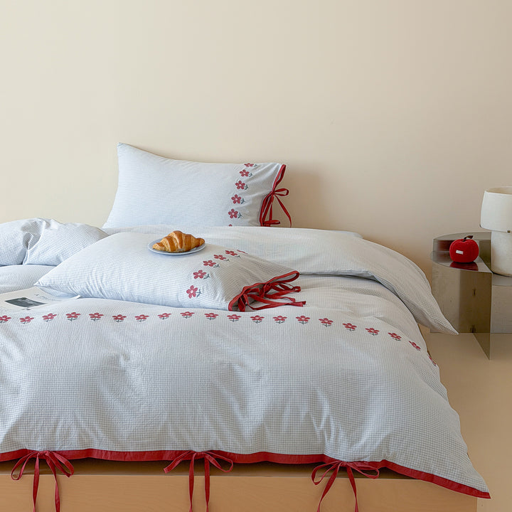Reversible cotton bedding set with fine check pattern, cherry embroidery, and decorative tie ribbons