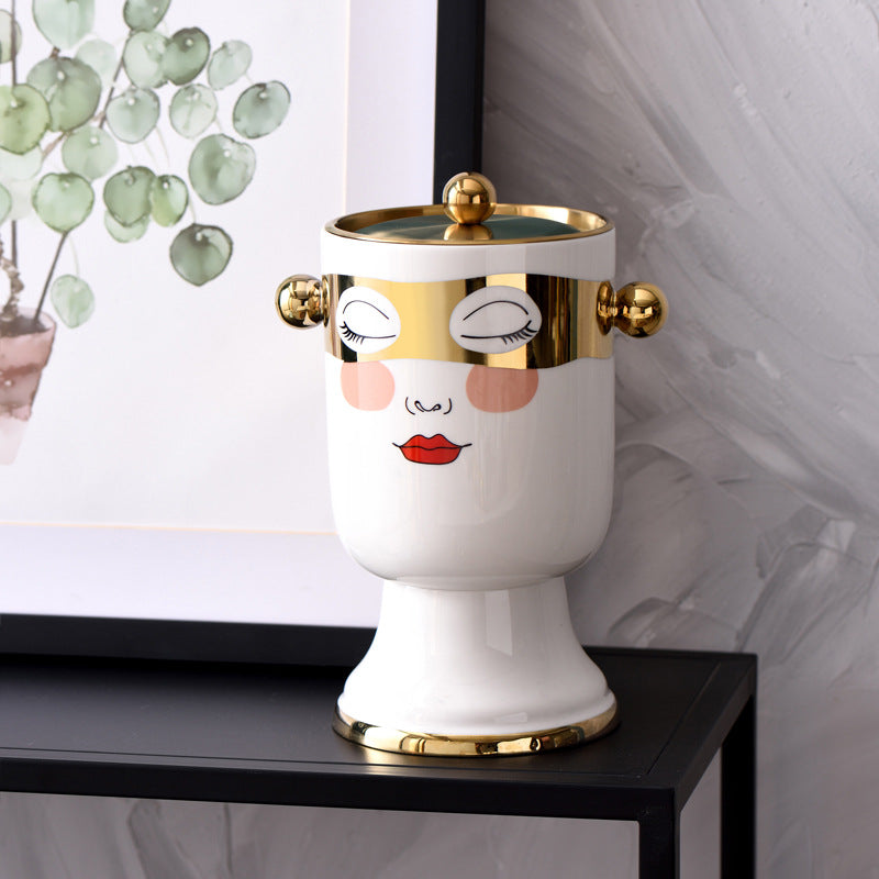 Decorative ceramic beverage dispenser with tap, hand-painted face and gold-finished lid