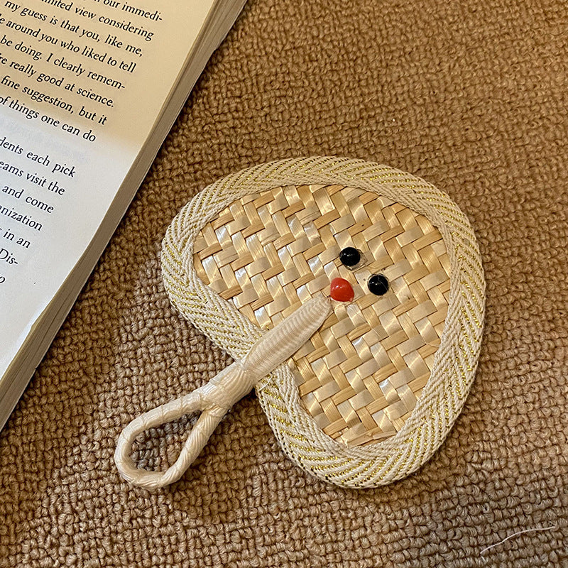 Handcrafted fan with playful face motif Kalsten