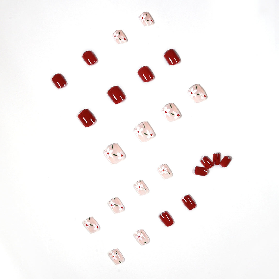 Artful nail art with floral motifs and glitter accents Kalsten