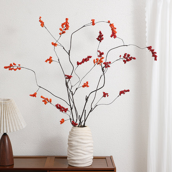Decorative artificial flower branch with glowing red berries