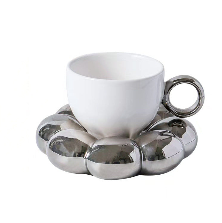 Ceramic mug with sculptural bubble saucer
