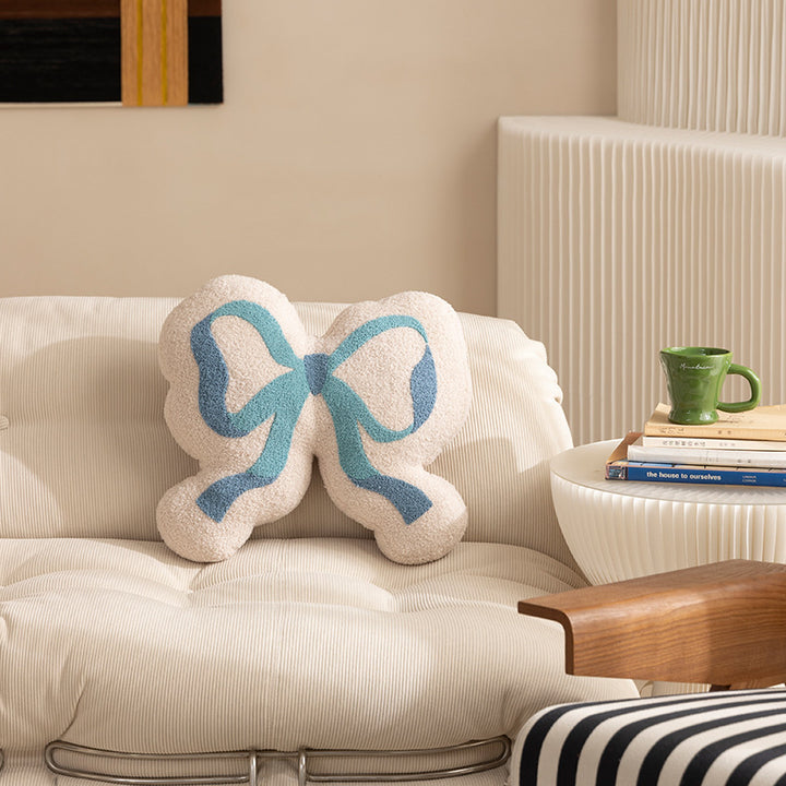 Bow decorative cushion made of boucle with fluffy teddy look