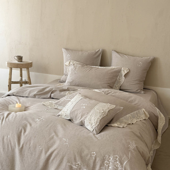 Vintage-inspired linen-cotton blend bedding set with floral chain stitch embroidery and lace trim