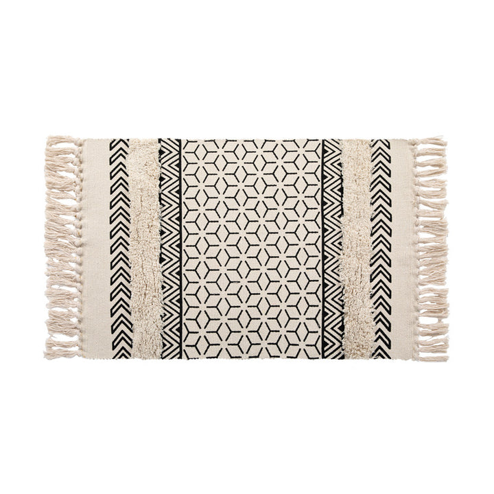 Flat Boho runner rug made of cotton blend fabric with geometric hexagon tufting and decorative fringed edge.