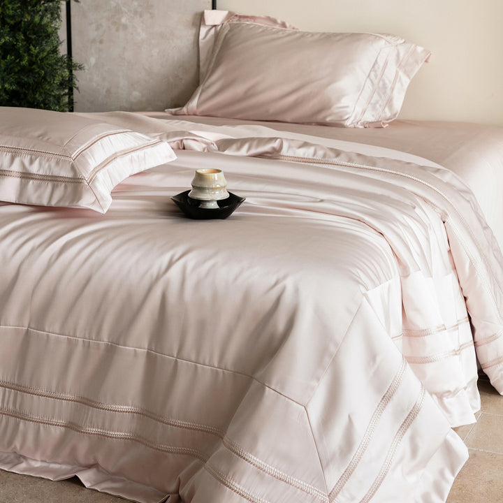 Luxurious satin bedding set with decorative borders and silky-smooth feel