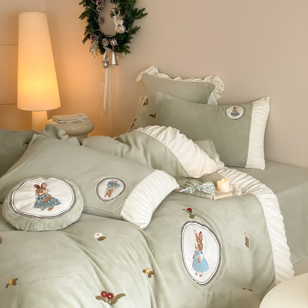 Quilted children's bedding set with embroidered bunny appliqués and ruffles