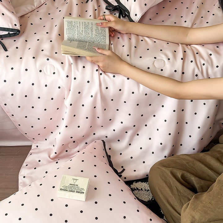 Satin bedding set with delicate polka dot pattern and satin finish