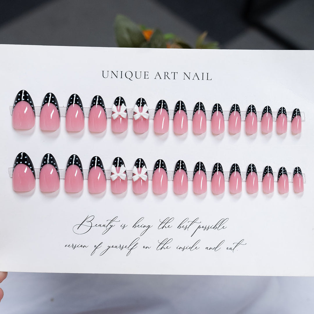 Decorative Stiletto Press-On Nail Art with Bow and Polka Dot Design